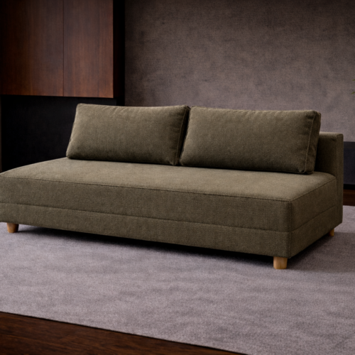 Juby bäddsoffa i grönt tyg som utställningsexemeplar.